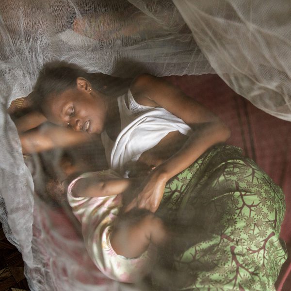 Issata Sow, 26, lies under a mosquito net with her 4-month-old daughter Davida Batu in Freetown, Sierra Leone on Monday September 30, 2013.